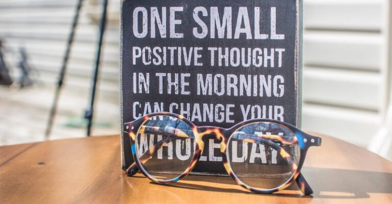 Positive Thinking - Photo of a Sign and Eyeglasses on Table