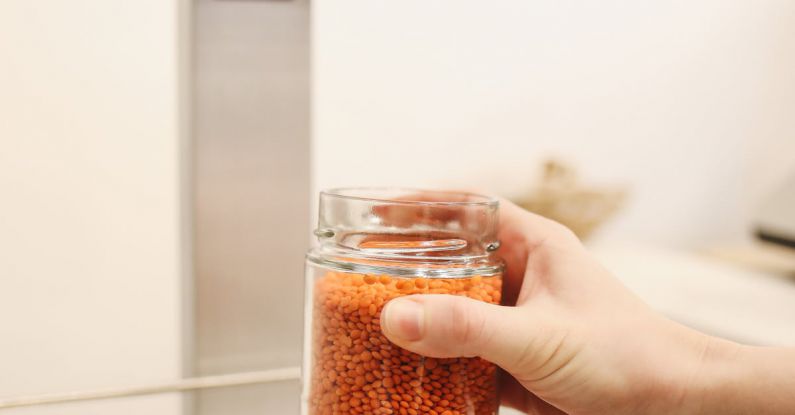 Work Ethic - Person Holding Clear Glass Jar With Brown Substance