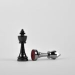 Strategies - Two Silver Chess Pieces on White Surface