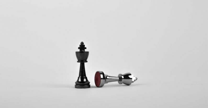 Strategies - Two Silver Chess Pieces on White Surface